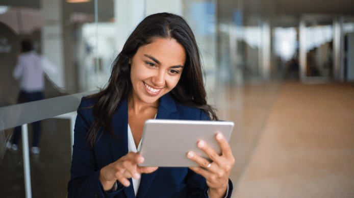 Law firm employee smiling at her tablet as she sees inbox zero